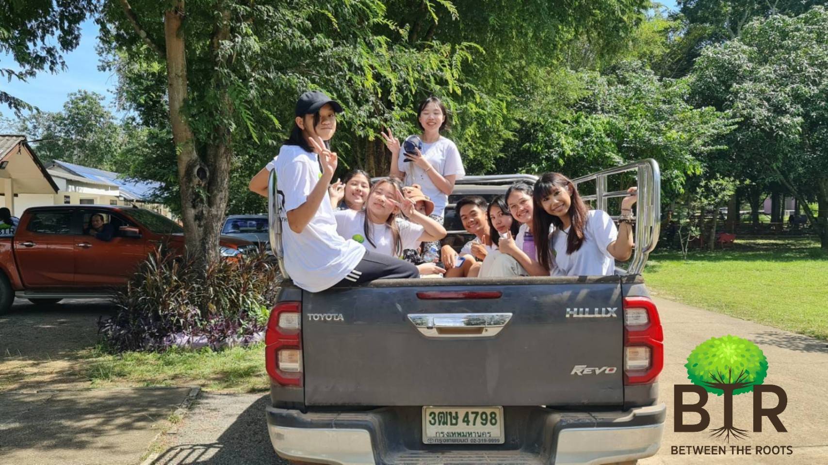 BTR members riding together in the back of a pickup truck