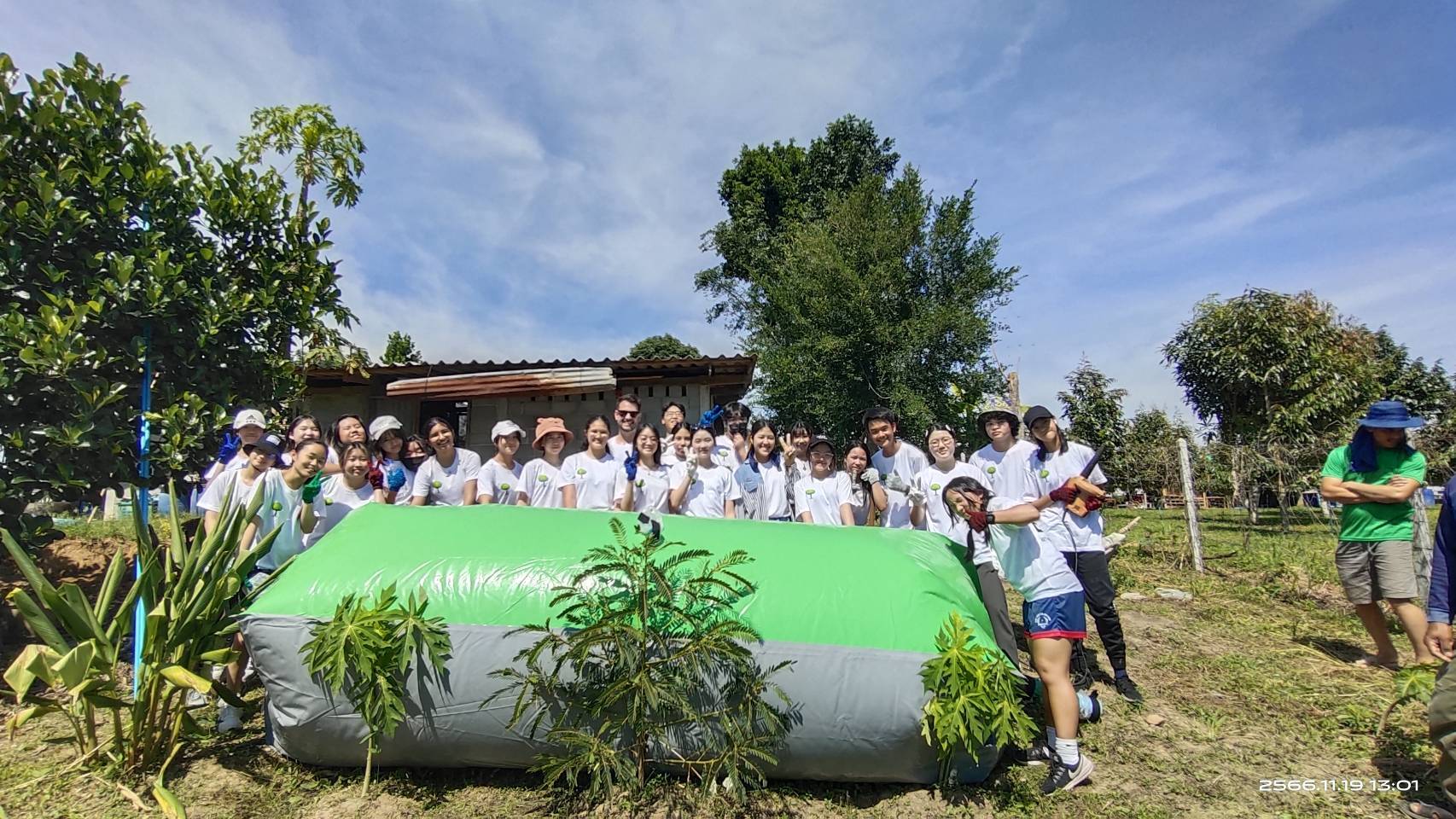The team gathered around the newly installed biogas balloon