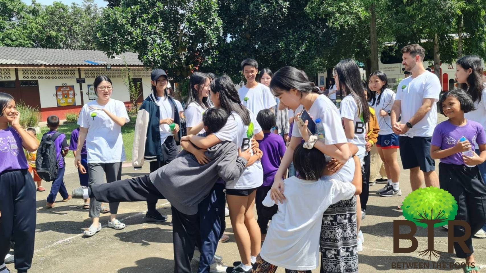 BTR members hugging the children goodbye in the schoolyard